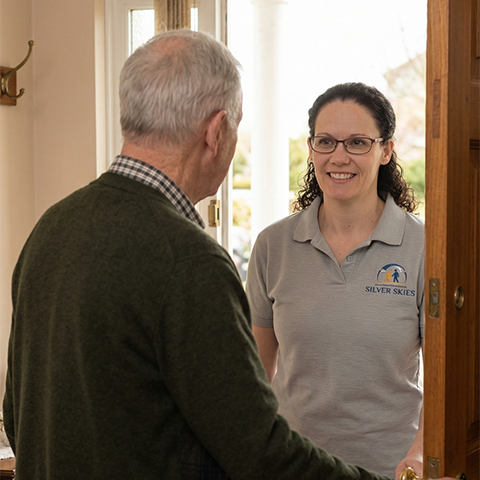 Kathrine and a client sharing a happy moment together in the client's home, illustrating the friendly, supportive, and personal nature of Silver Skies companionship.